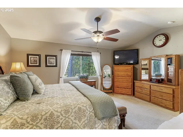 a bedroom with a large bed and a chandelier