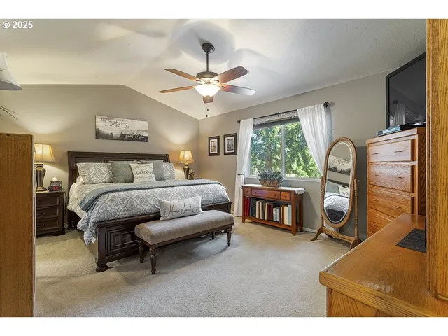 a bedroom with a bed dresser and a window