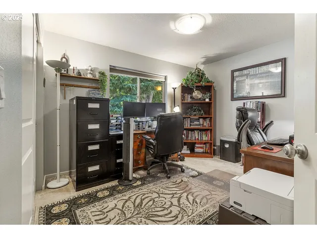 a living room with furniture a desk and chair