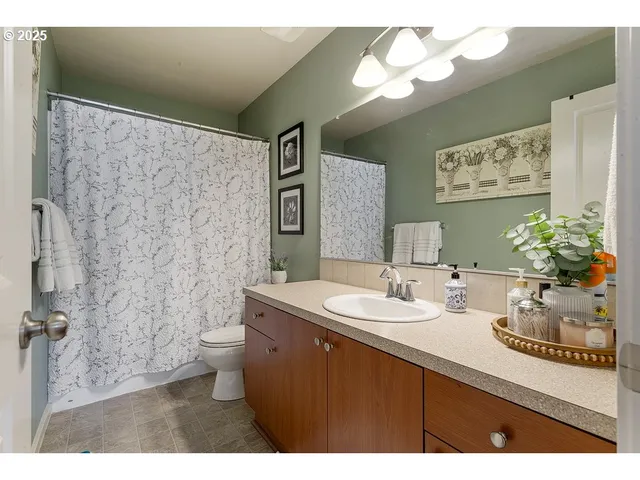 a bathroom with a sink mirror and a toilet