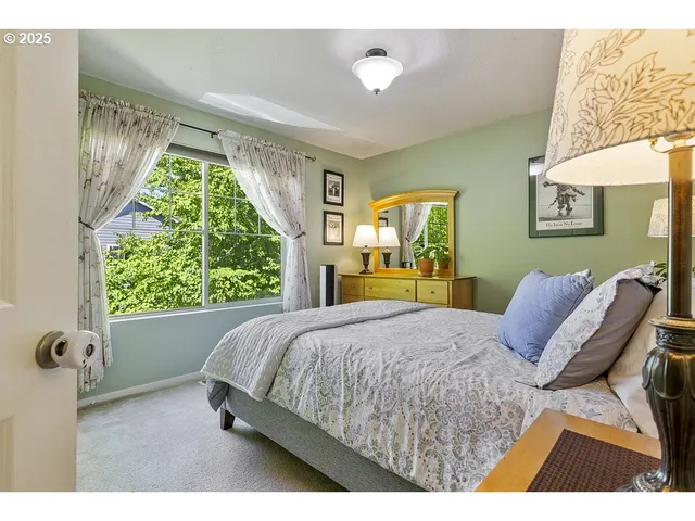 a bedroom with a bed and a large window