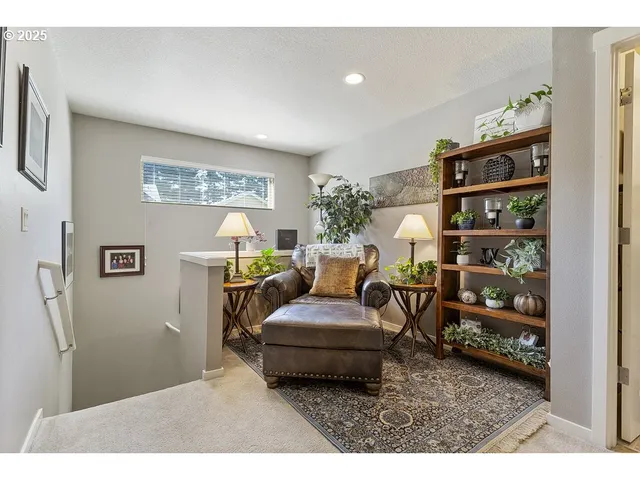 a living room with furniture and a book shelf