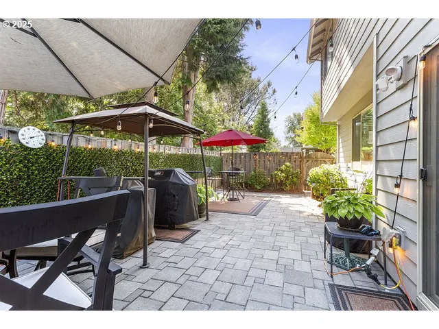 a view of a patio with table and chairs under an umbrella