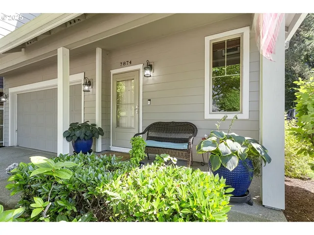 a front view of a house with a garden