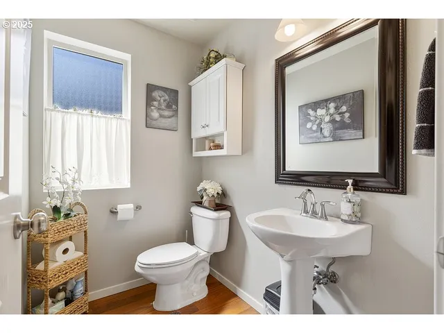 a bathroom with a toilet a sink and mirror