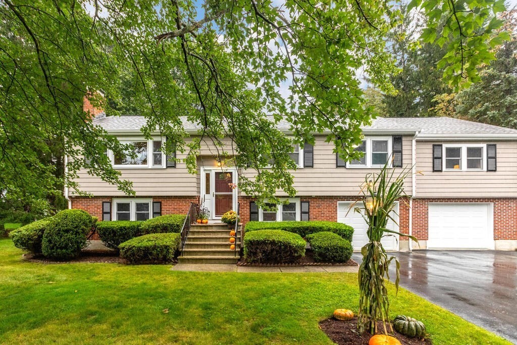 11 Augustus Road Lexington, MA 02421 - Photo 1 of 31 a front view of a house with a garden and yard