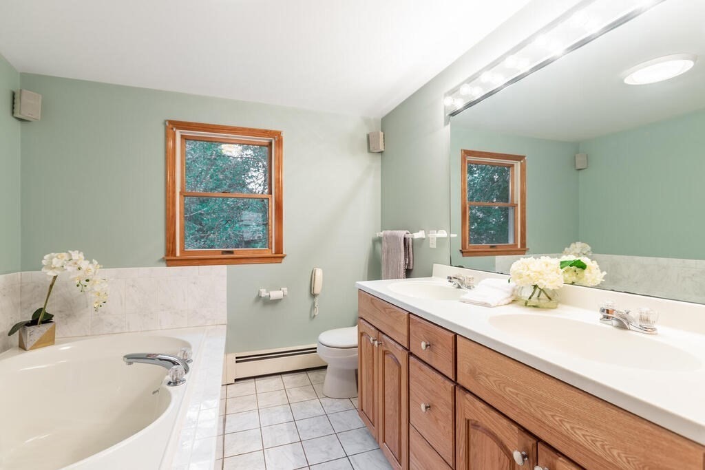 11 Augustus Road Lexington, MA 02421 - Photo 19 of 31 a bathroom with a tub a sink and mirror
