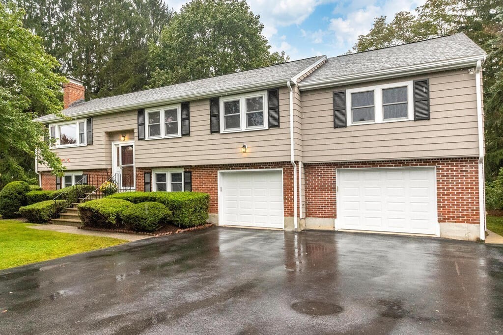 11 Augustus Road Lexington, MA 02421 - Photo 2 of 31 a front view of a house with a yard and garage