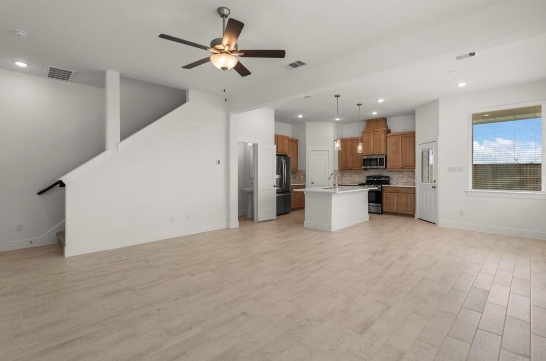5234 Capricorn Way Manvel, TX 77578 - Photo 4 of 25 a view of a kitchen with a sink and a refrigerator