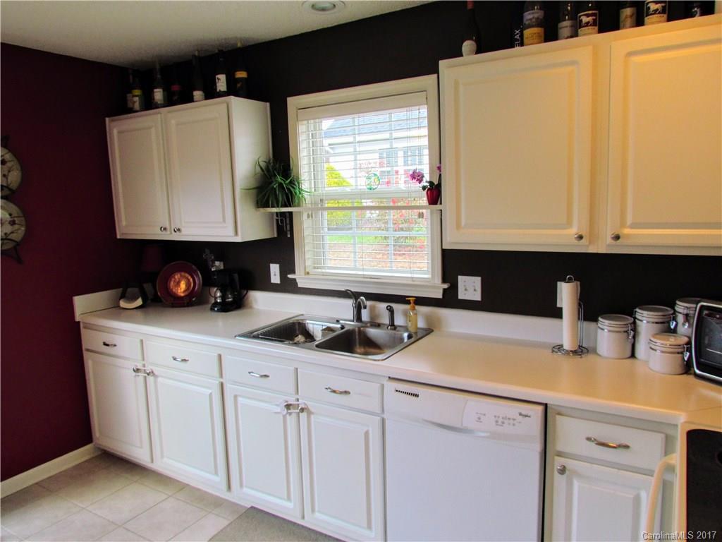 216 Planters Creek Road Fletcher, NC 28732 - Photo 22 of 24 a kitchen with white cabinets and window