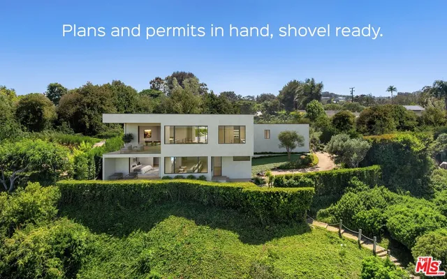 a view of a house with a yard and potted plants