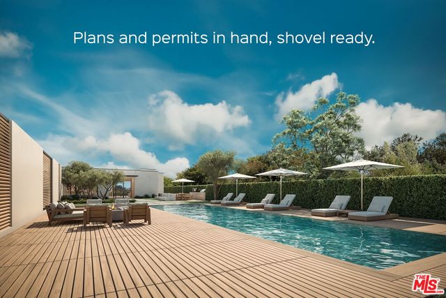 a view of a patio with table and chairs under an umbrella with wooden fence