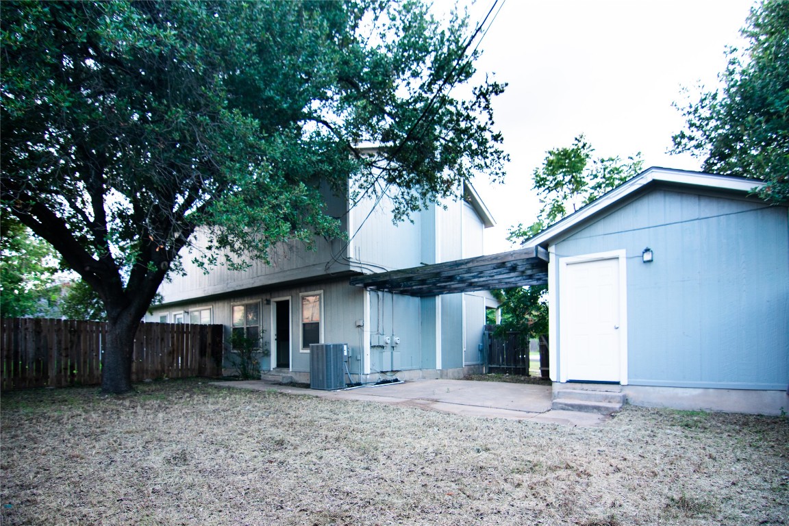8807 Springmail Circle, Unit A Austin, TX 78729 - Photo 12 of 27 a front view of a house with a garden and trees
