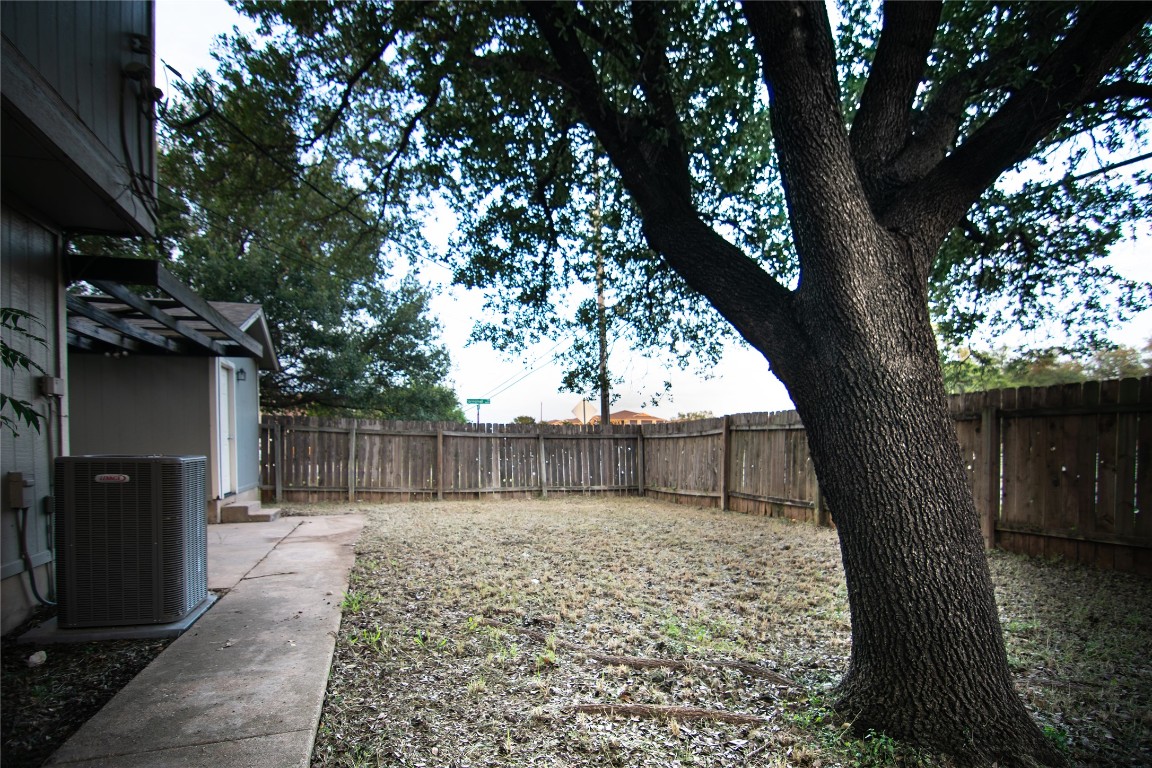 8807 Springmail Circle, Unit A Austin, TX 78729 - Photo 13 of 27 a view of a backyard with a tree