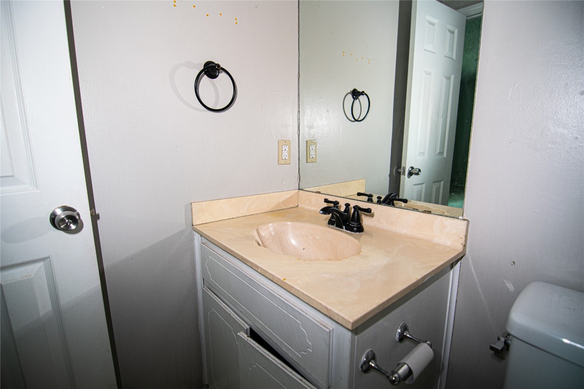 8807 Springmail Circle, Unit A Austin, TX 78729 - Photo 20 of 27 a bathroom with a granite countertop sink and a mirror
