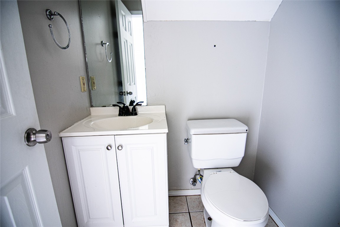 8807 Springmail Circle, Unit A Austin, TX 78729 - Photo 22 of 27 a bathroom with a toilet and a mirror