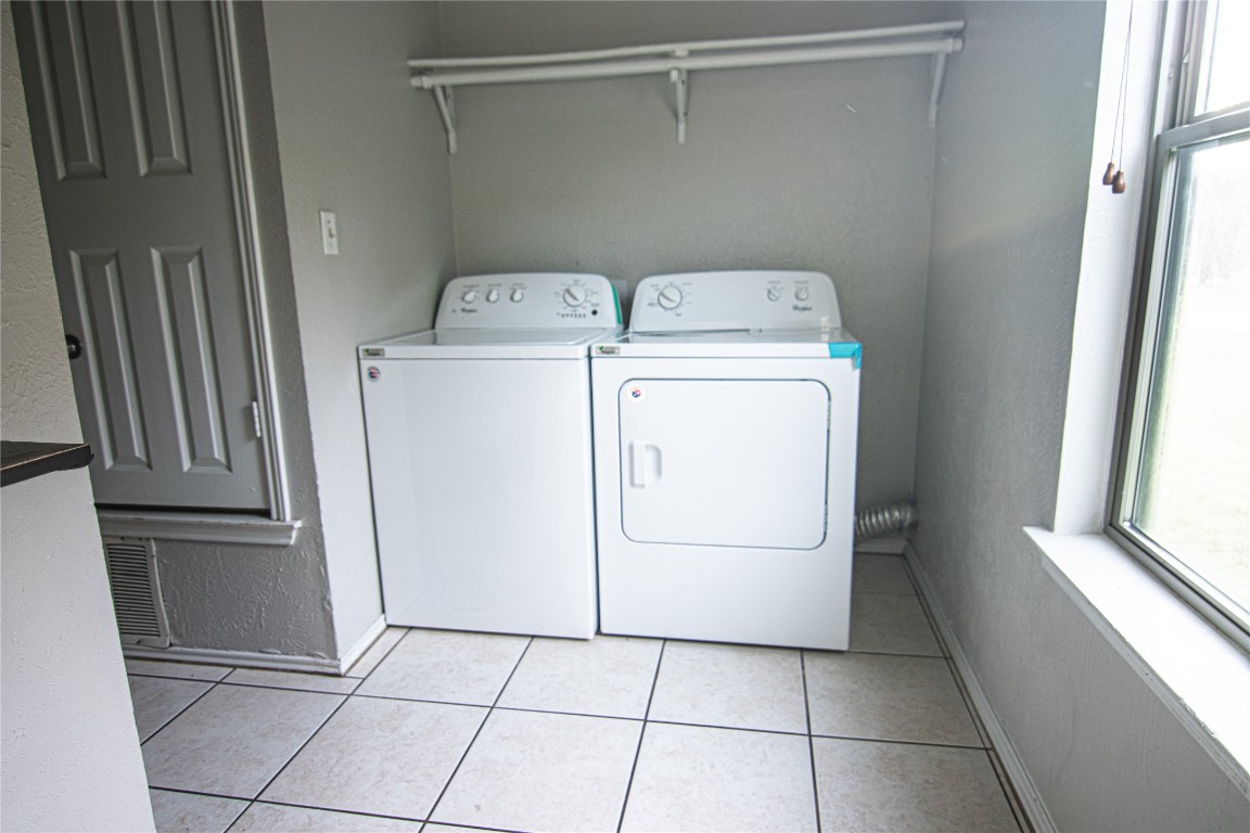 8807 Springmail Circle, Unit A Austin, TX 78729 - Photo 23 of 27 a utility room with dryer and washer