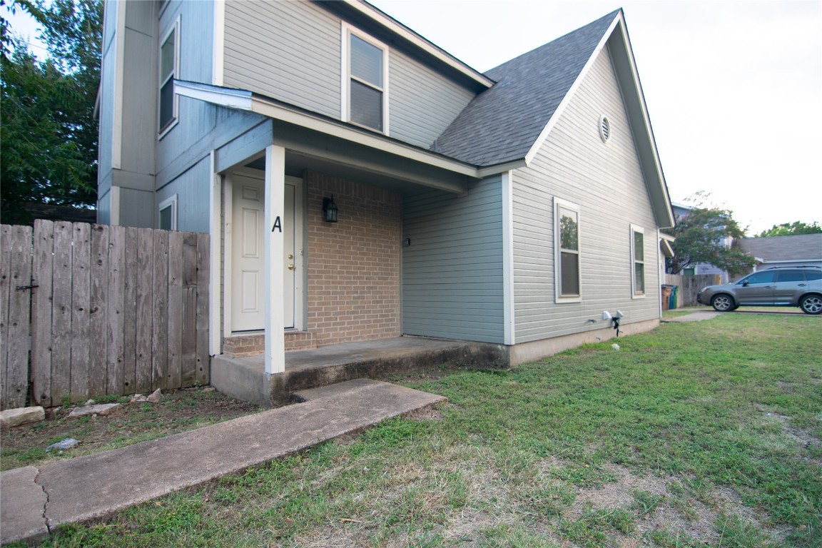 8807 Springmail Circle, Unit A Austin, TX 78729 - Photo 6 of 27 a front view of a house with a yard