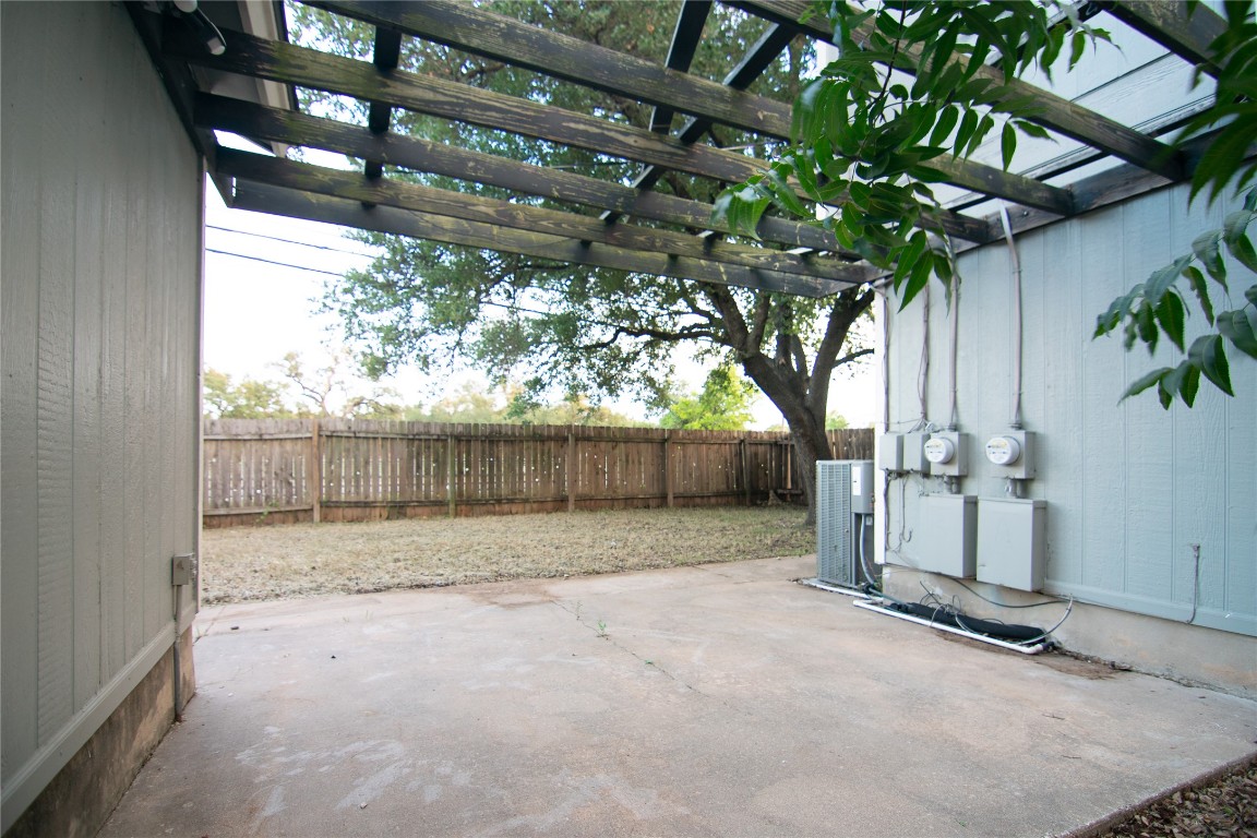 8807 Springmail Circle, Unit A Austin, TX 78729 - Photo 9 of 27 a view of backyard and tree