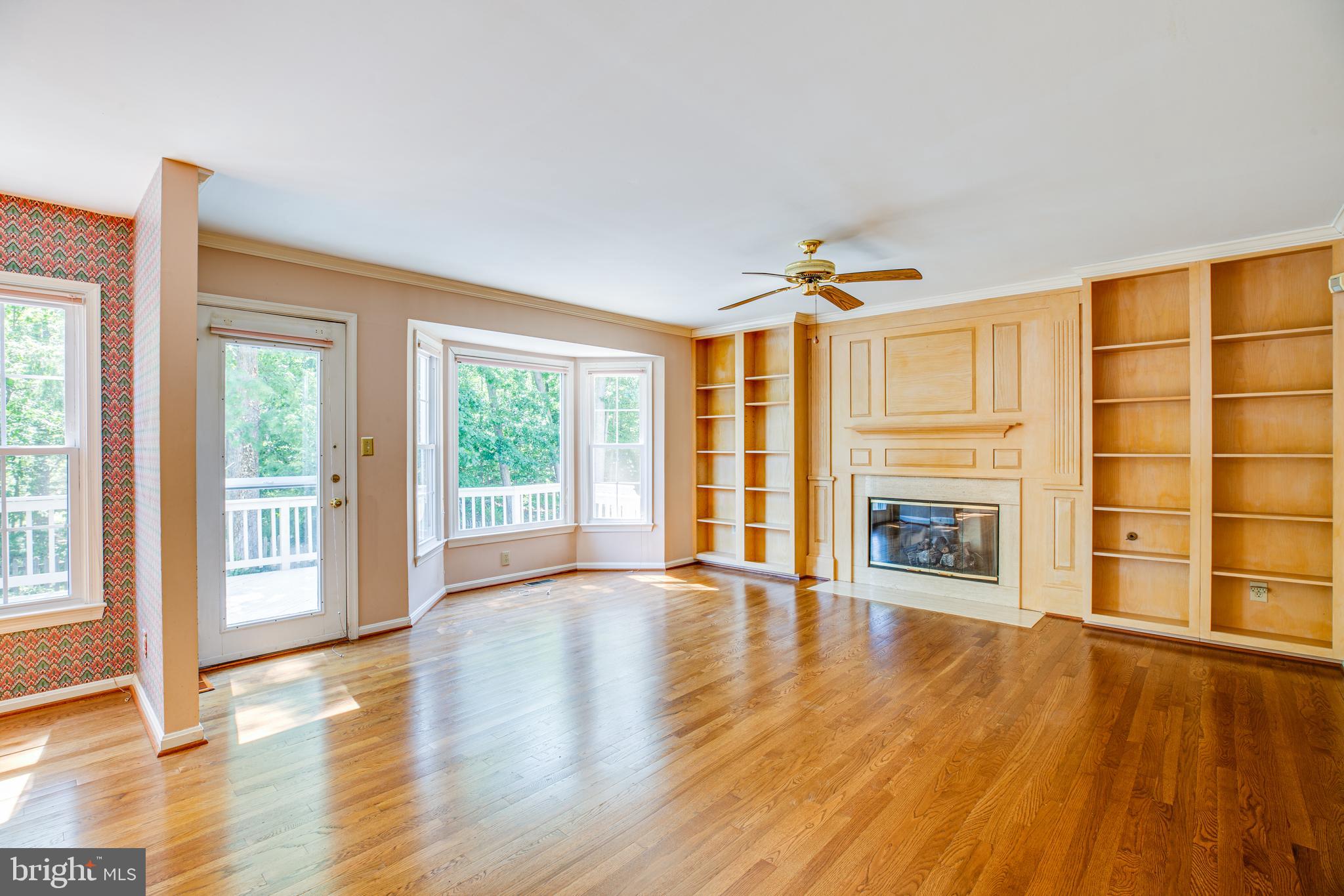 Wood floors & custom shelving accentuate family rm