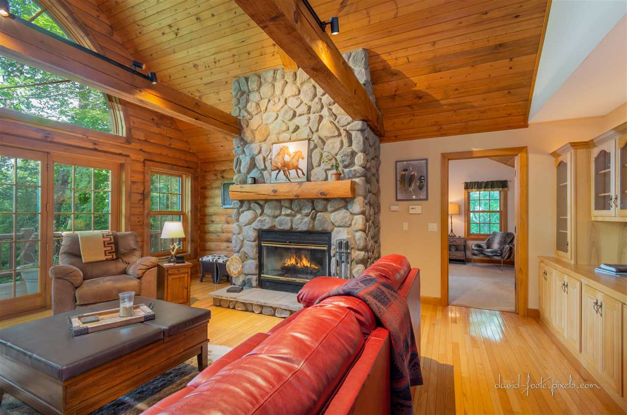 8620 Fisher Road Hanover, IL 61041 - Photo 12 of 49 a living room with furniture a fireplace and wooden floor