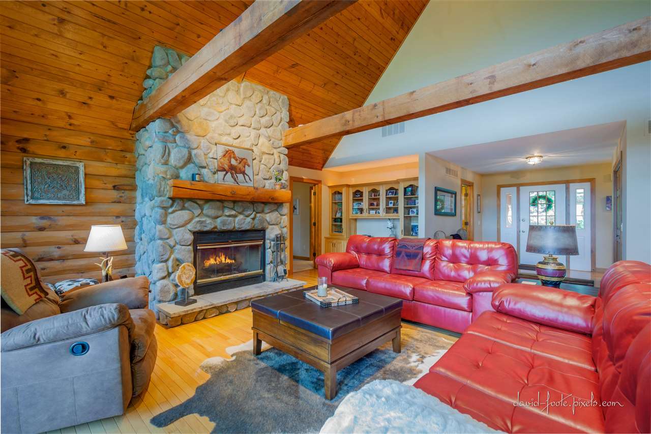 8620 Fisher Road Hanover, IL 61041 - Photo 13 of 49 a living room with furniture a fireplace and a large window