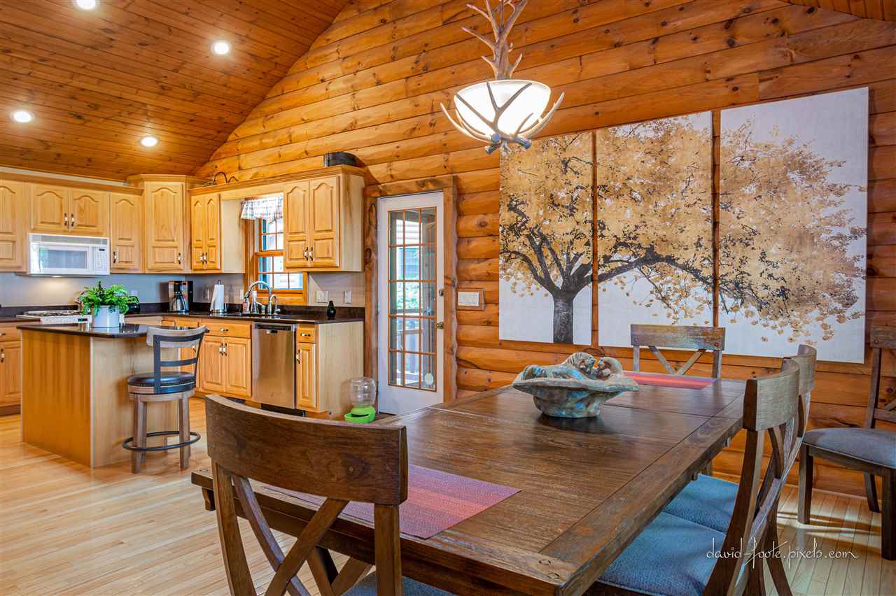 8620 Fisher Road Hanover, IL 61041 - Photo 15 of 49 a dining room with furniture a chandelier and wooden floor