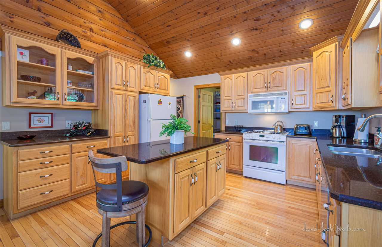 8620 Fisher Road Hanover, IL 61041 - Photo 18 of 49 a kitchen with stainless steel appliances granite countertop a stove a sink dishwasher and cabinets with wooden floor