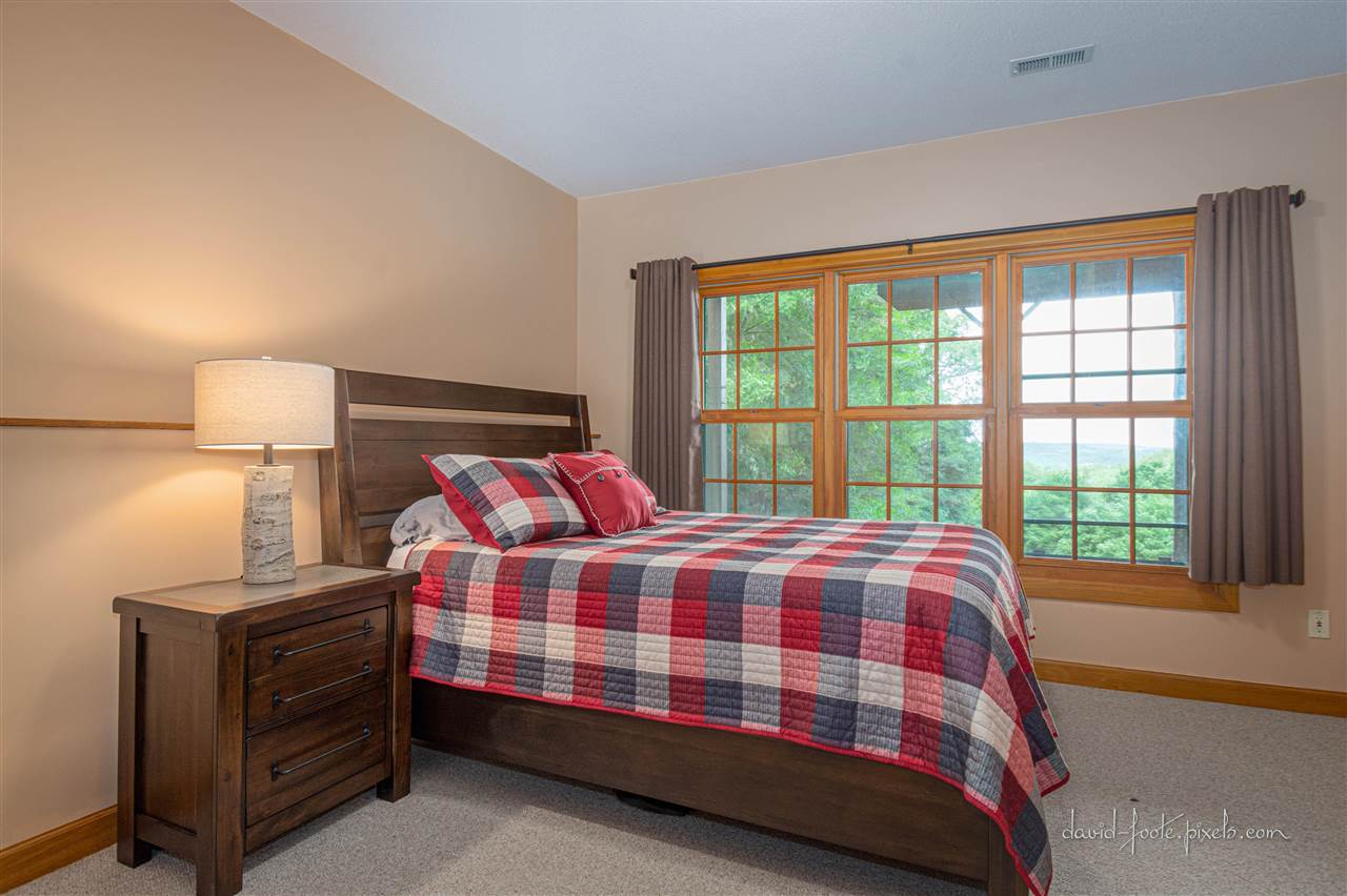 8620 Fisher Road Hanover, IL 61041 - Photo 31 of 49 a bedroom with a bed and a lamp next to a window