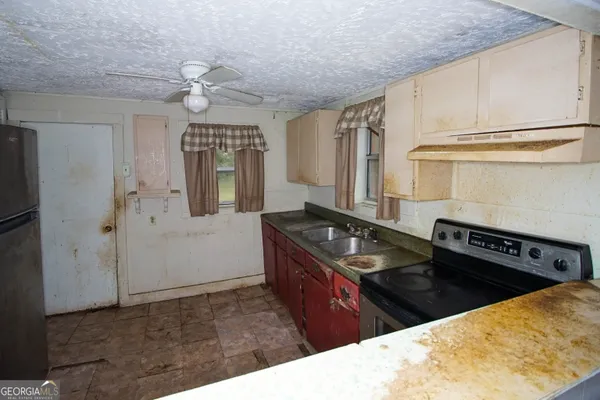 a kitchen with a sink stove and refrigerator