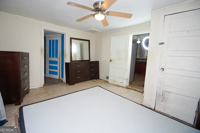 a bedroom with a dresser and a chandelier