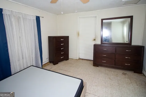 a room with a bed and a mirror