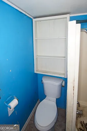 a white toilet sitting next to a bathroom sink