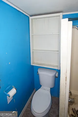 a white toilet sitting next to a bathroom sink