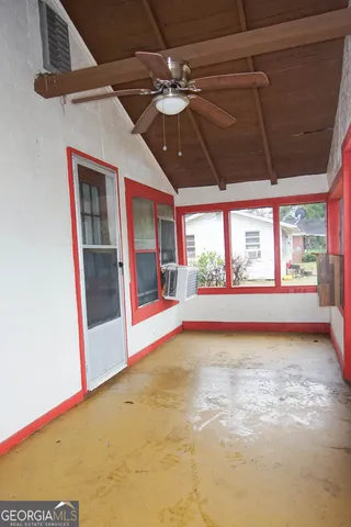 a view of a room with a large window and chandelier