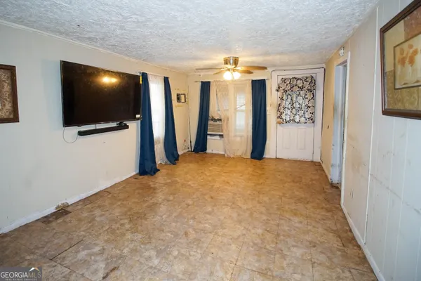 a view of a livingroom with wooden floor and a flat screen tv