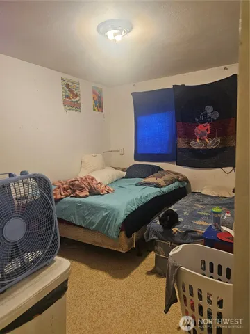 a bedroom with a bed and dresser