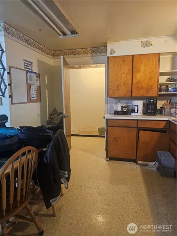 a view of a kitchen with a sink and cabinets