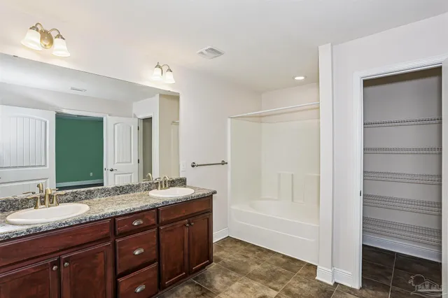 a bathroom with a granite countertop sink mirror and double