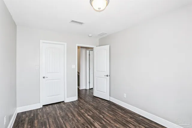 a view of room with wooden floor