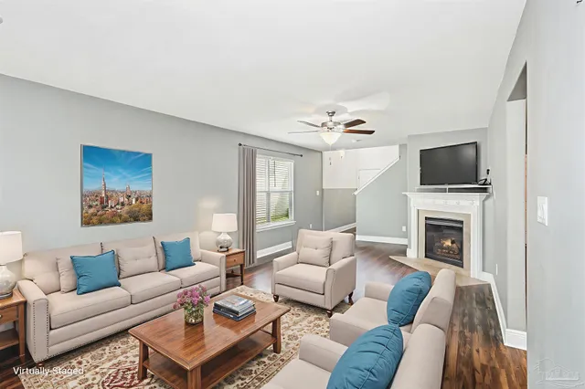 a living room with furniture a fireplace and a flat screen tv