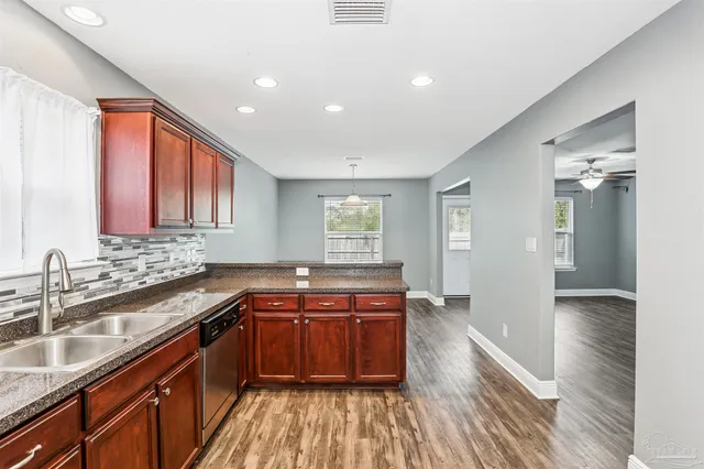 a kitchen with a sink stove and cabinets