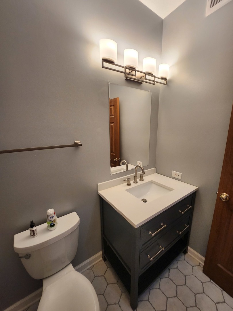 316 East Victoria Circle, Unit 316 North Aurora, IL 60542 - Photo 17 of 54 a bathroom with a sink mirror and toilet