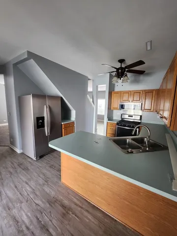 a view of a livingroom with wooden floor and chandelier
