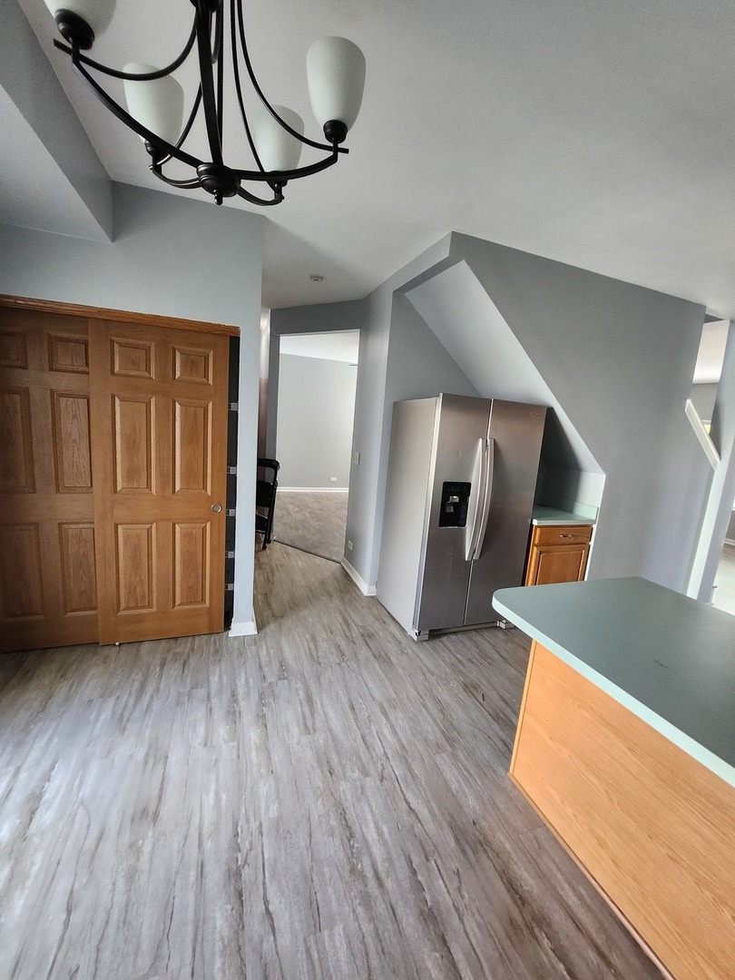 316 East Victoria Circle, Unit 316 North Aurora, IL 60542 - Photo 25 of 54 a view of an entryway and wooden floor