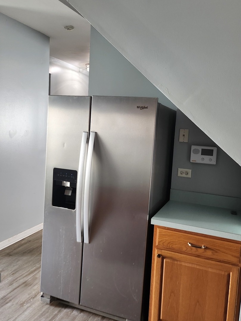 316 East Victoria Circle, Unit 316 North Aurora, IL 60542 - Photo 26 of 54 a close view of a refrigerator in kitchen and a wooden floor
