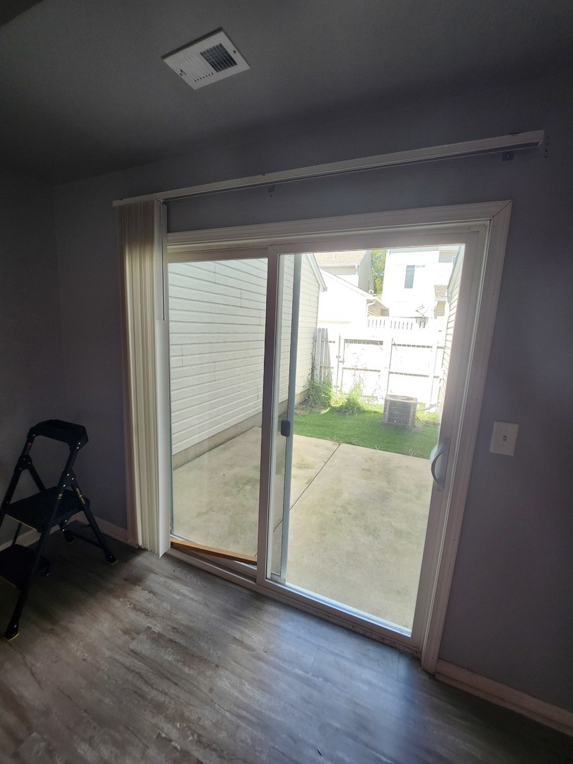 316 East Victoria Circle, Unit 316 North Aurora, IL 60542 - Photo 32 of 54 a view of an empty room and wooden floor and a window