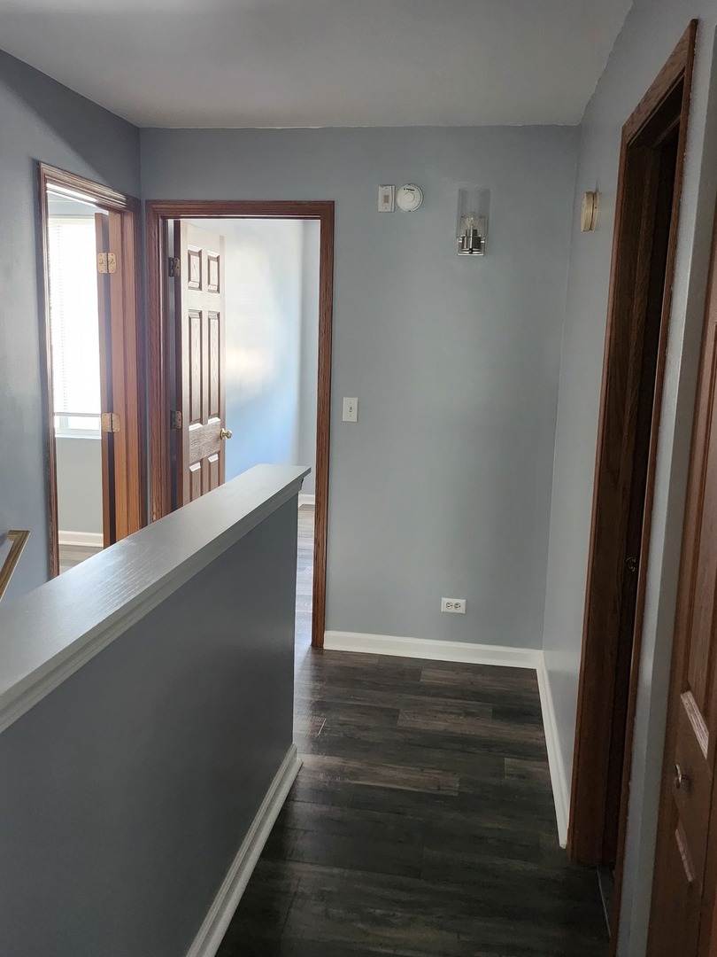 316 East Victoria Circle, Unit 316 North Aurora, IL 60542 - Photo 35 of 54 a view of a hallway with wooden floor