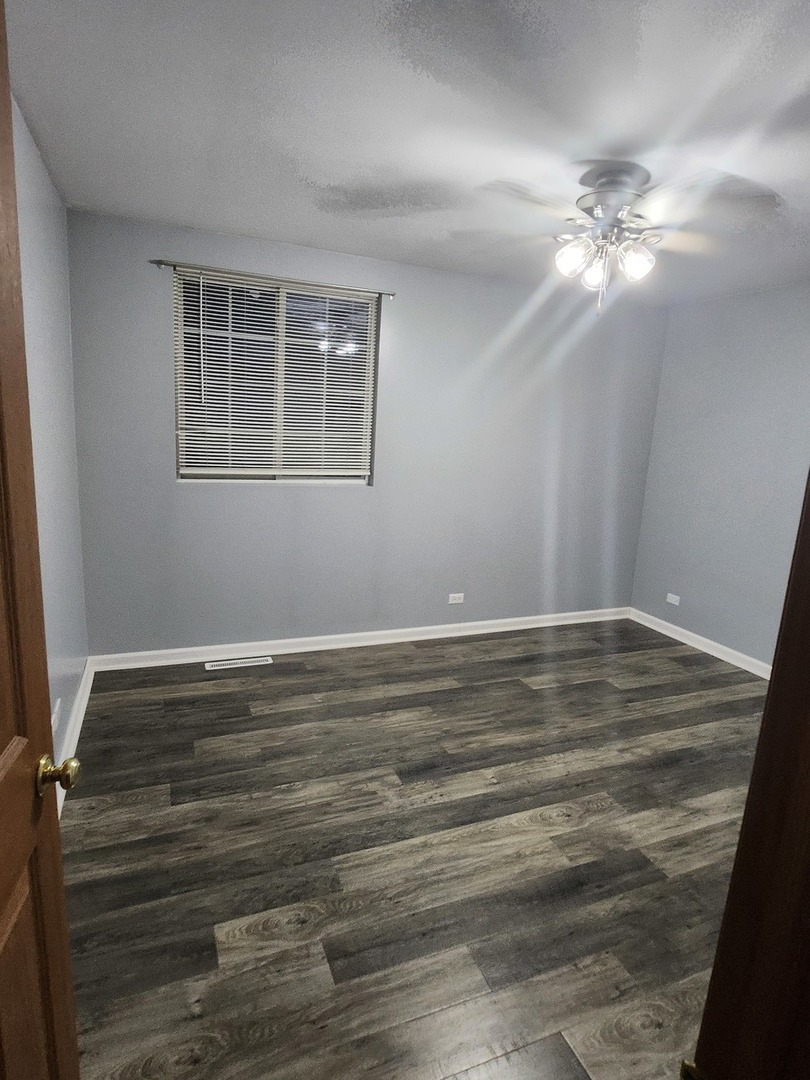 316 East Victoria Circle, Unit 316 North Aurora, IL 60542 - Photo 39 of 54 a view of a room with window and wooden floor
