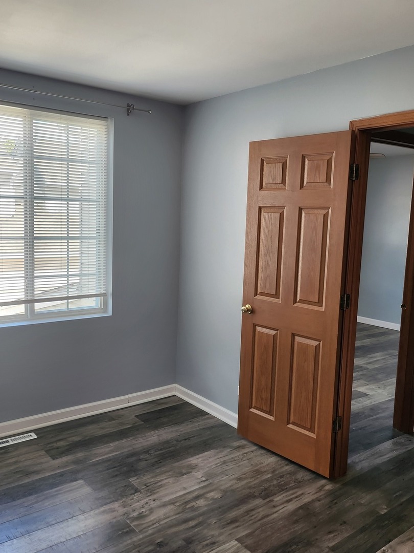 316 East Victoria Circle, Unit 316 North Aurora, IL 60542 - Photo 41 of 54 a view of empty room with wooden floor
